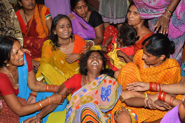 An Indian widow is comforted by relatives and friends after the death of her husband on the outskirts of Patna on May 12, 2015, after a new 7.3 earthquake and several powerful aftershocks hit neighbouring devastated Nepal.