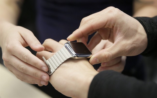 Customers examine Apple's new watch in New York.