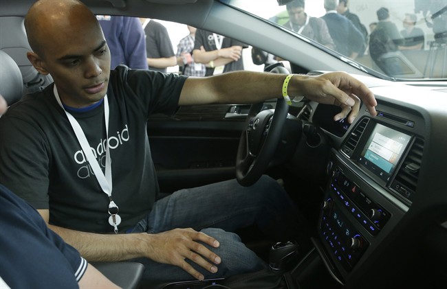 An Android employee gives a demonstration of Android Auto during Google I/O 2014 in San Francisco. By the end of the year, nearly every major automaker will begin offering Apple’s CarPlay or Google’s Android Auto systems that will send smart phone looks and functions to dashboard screens. 