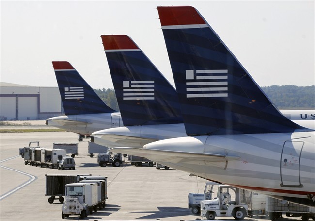  US Airways jets are parked at their gates at the Charlotte/Douglas International airport in Charlotte, N.C.