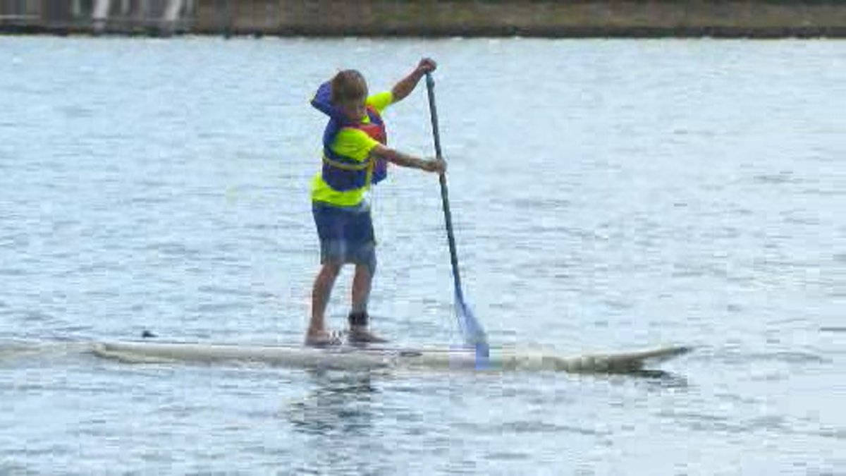 Finn Redman, 8, paddles a stand up paddleboard on Okanagan Lake in front of the Kelowna Paddle Centre. 