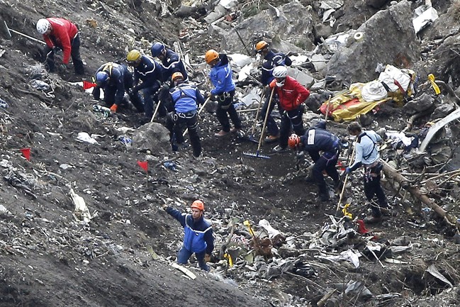 FILE - In this March 26, 2015 file photo, rescue workers work on debris of the Germanwings jet at the crash site near Seyne-les-Alpes, France.
