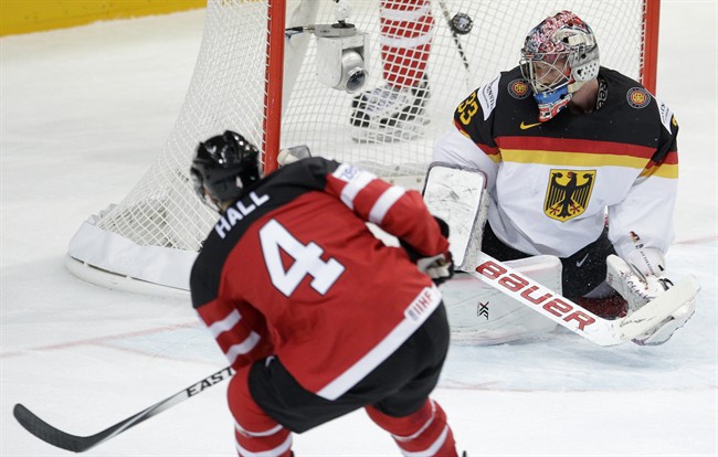 Canada’s Taylor Hall, left, scores his third goal of the game past Germany's Danny aux den Birken, right, during the Hockey World Championships Group A match in Prague, Czech Republic, Sunday, May 3, 2015.