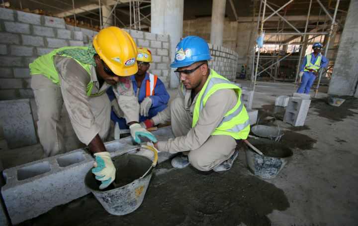 Migrant labourers work on a construction site on October 3, 2013 in Doha in Qatar. Qatar, the 2022 World Cup host has faced criticism over its treatment of migrant workers in the construction of stadiums and other facilities.