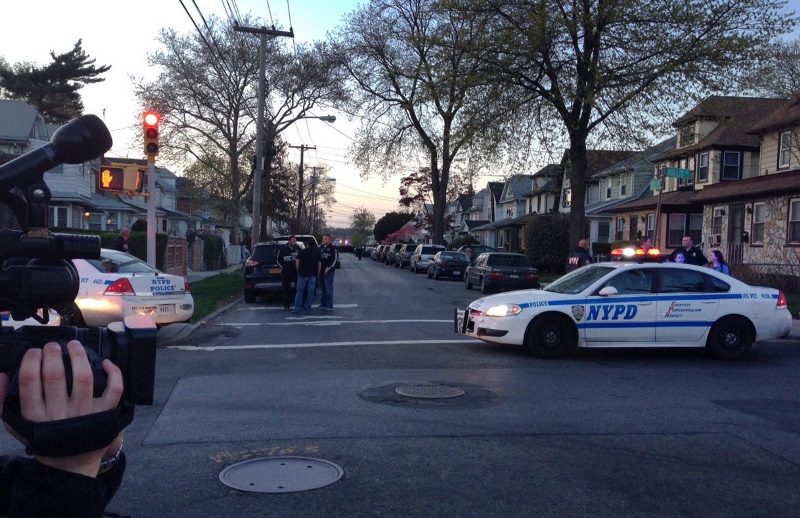 Police vehicles park near the site where a police officer was shot in the Queens Village neighborhood of New York on Saturday, May 2, 2015. 