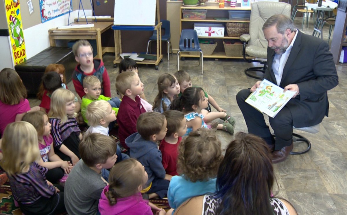 NDP leader Tom Mulcair reads the Saskatchewan Roughriders-themed illustrated book, 'The Always Team - The Search For Rider Nation' to a group of children in Regina on May 1, 2015.