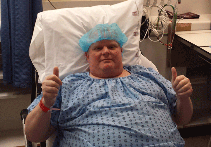 Rob Ford is seen dressed in a blue hospital gown as he heads into surgery on May 11, 2015.
