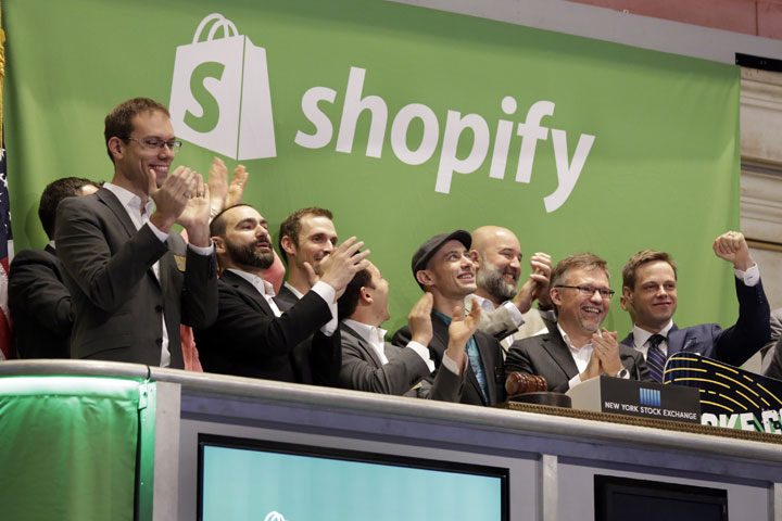 Shopify CEO Tobias Lutke, center wearing hat, is celebrated as he rings the New York Stock Exchange opening bell, marking the Canadian company's IPO, Thursday, May 21, 2015. 