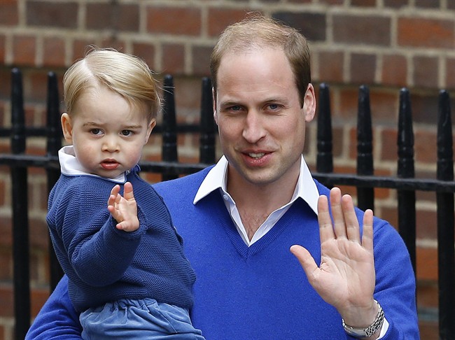 Britain's Prince William and his son Prince George wave as they return to St. Mary's Hospital's exclusive Lindo Wing, London, Saturday, May 2, 2015.