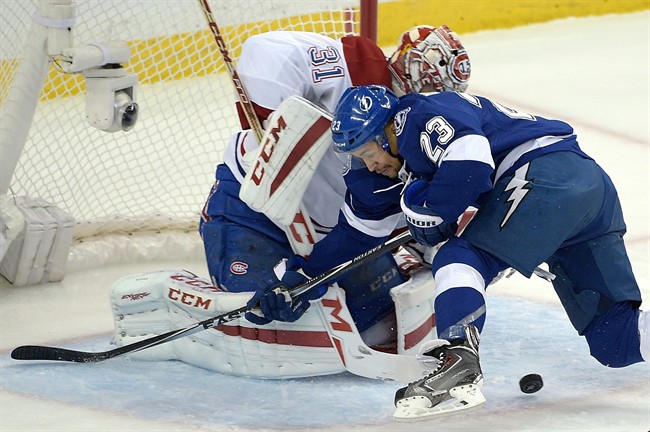 Montreal Canadiens goalie Carey Price (31) blocks a shot attempt by Tampa Bay Lightning right wing J.T. Brown (23) during the first period of Game 3 of a second-round NHL Stanley Cup hockey playoff series in Tampa, Fla., Wednesday, May 6, 2015.
