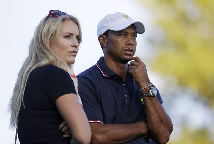 This Oct. 3, 2013 file photo shows Tiger Woods watching with his girlfriend Lindsey Vonn at the Presidents Cup golf tournament at Muirfield Village Golf Club in Dublin, Ohio. 