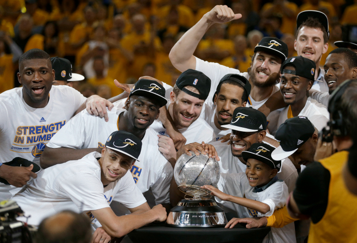 Golden State Warriors players celebrate after Game 5 of the NBA basketball Western Conference finals against the Houston Rockets in Oakland, Calif., Wednesday, May 27, 2015. The Warriors won 104-90 and advanced to the NBA Finals. 