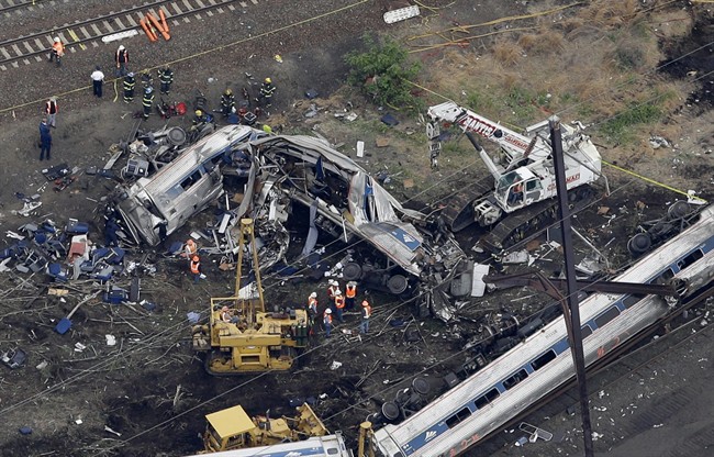 In this aerial photo taken May 13, 2015, emergency personnel work at the scene of a deadly train wreck in Philadelphia. 