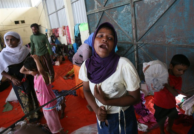 An ethnic Rohingya woman who said she got separated from her brother cries at a temporary shelter in Langsa, Aceh province, Indonesia, Saturday, May 16, 2015.