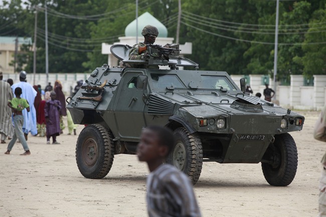 Nigerian soldiers ride on an armored personnel carrier during Eid al-Fitr celebrations in Maiduguri, Nigeria. 