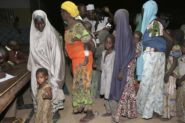 Women and children rescued by Nigerian soldiers from captivity from Islamist extremists at Sambisa forest, register their names on arrival at a camp in Yola, Nigeria, Saturday May. 2, 2015. 