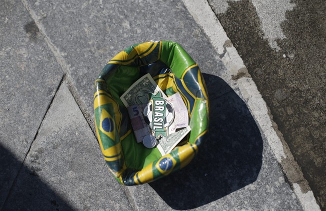 A soccer ball designed with Brazil's national colors, formed by a street performer into a receptacle to collect tips left by tourists, sits in front of the Maracana Stadium, in Rio de Janeiro, Brazil.