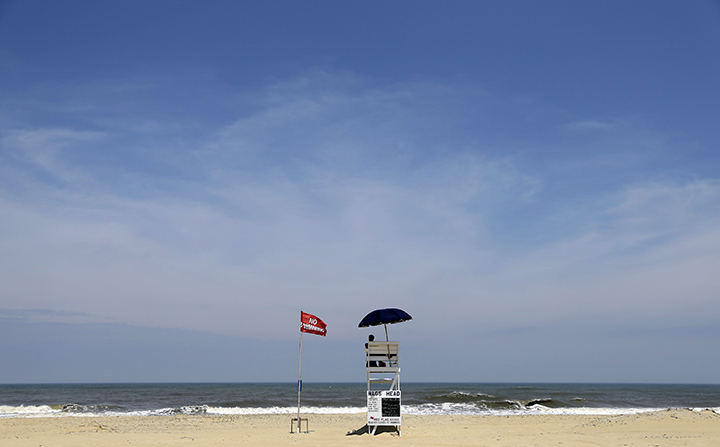A lifeguard displays a no swimming flag while keeping watch in Nags Head, N.C.