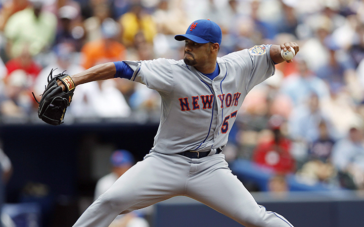 New York Mets starting pitcher Johan Santana works in a baseball game against the Atlanta Braves in Atlanta. The Toronto Blue Jays signed two-time Cy Young winner Santana to a minor league contract.