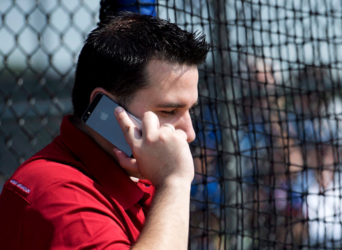 Toronto Blue Jays general manager Alex Anthopoulos talks on the phone during baseball spring training in Dunedin, Fla., on Friday, March 1, 2015. 