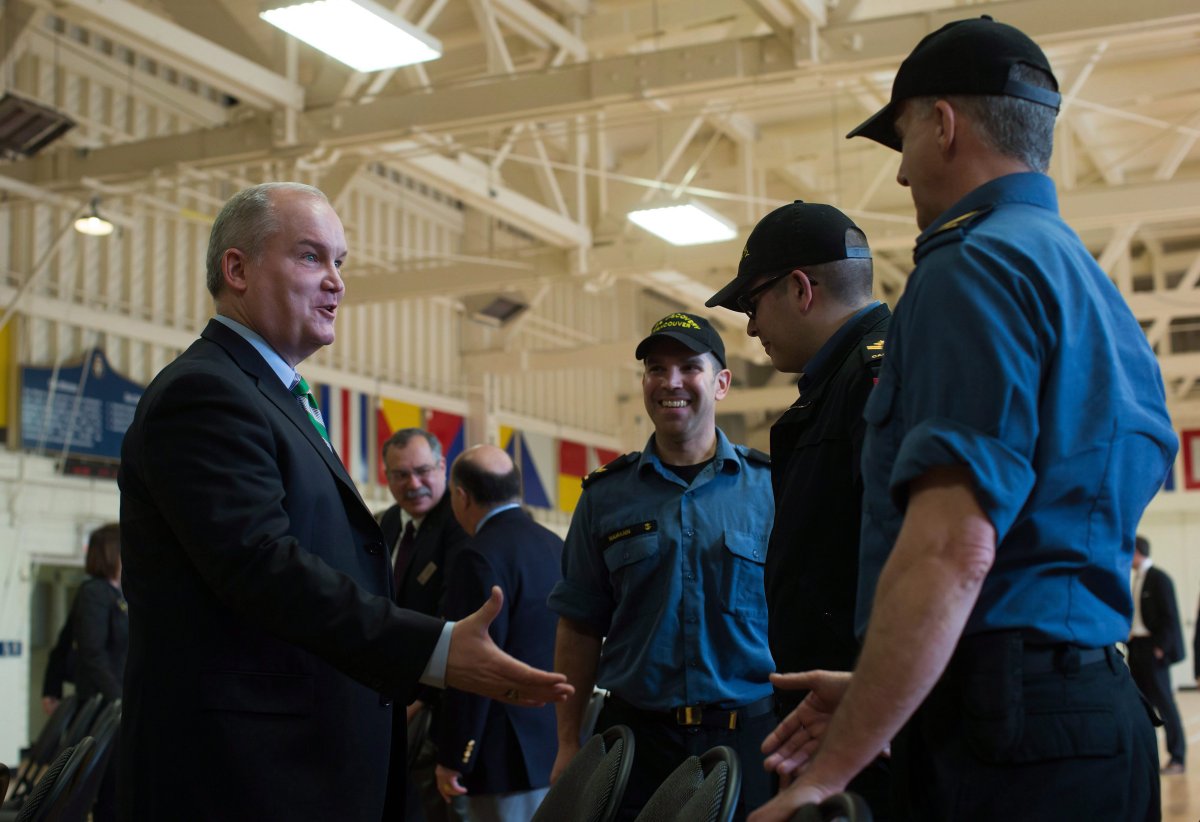 Minister of Veterans Affairs Erin O'Toole, left, greets members of the Royal Canadian Navy Reserve at HMCS Discovery after announcing improved benefits for veterans and their families, in Vancouver, B.C., on Tuesday March 17, 2015. 