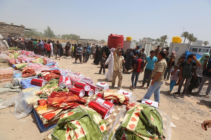 Displaced civilians from Ramadi wait to receive humanitarian aid from the United Nations in a camp in the town of Amiriyat al-Fallujah, west of Baghdad, Iraq, Friday, May 22, 2015. The United Nations World Food Program said it is rushing food assistance into Anbar to help tens of thousands of residents who have fled Ramadi after it was taken by Islamic State militant group. (AP Photo/Hadi Mizban).