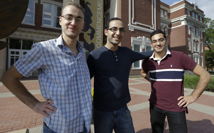 Syrian brothers Mohammad Kayali, left, Ebrahim Kayali, right and Molham Kayali, center, pose for a photograph on the Emporia State University campus in Emporia, Kan., Wednesday, May 6, 2015.  