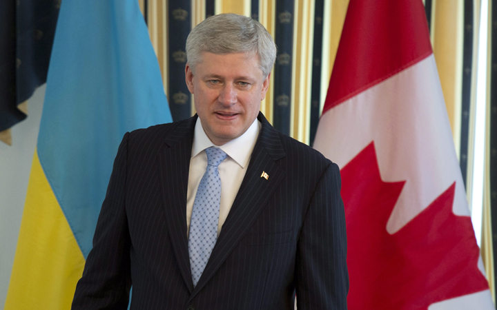Canadian Prime Minister Stephen Harper takes his seat before a meeting with Ukraine Prime Minister Arseniy Yatsenyuk on Saturday, June 6, 2015. 