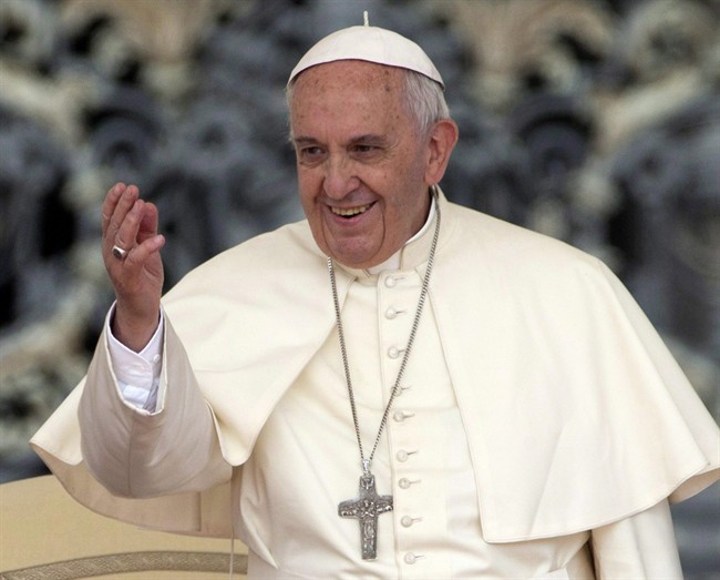 Pope Francis waves to faithful during his weekly general audience, in St. Peter's Square, at the Vatican.