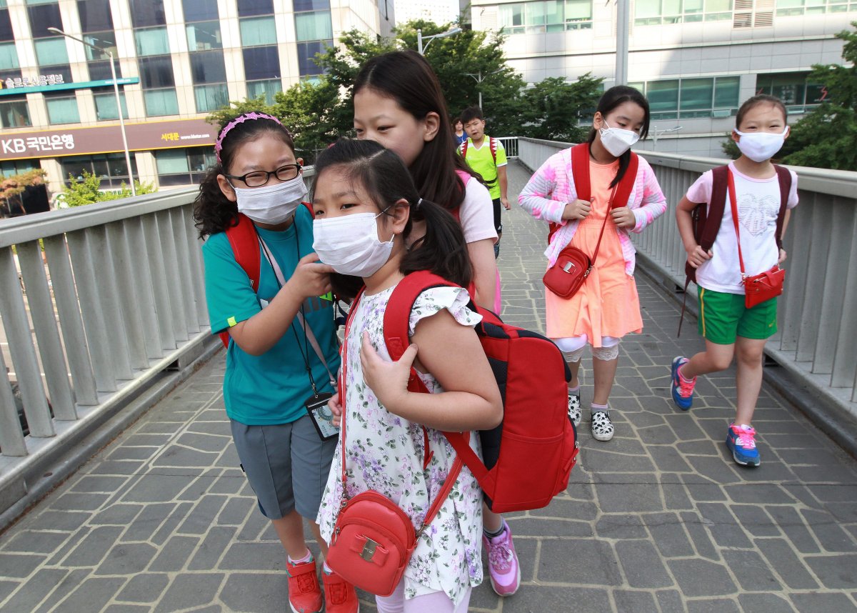 South Korean elementary school students wear masks as a precaution against the MERS, Middle East Respiratory Syndrome, virus as they go to school in Seoul, South Korea, Wednesday, June 10, 2015. 
