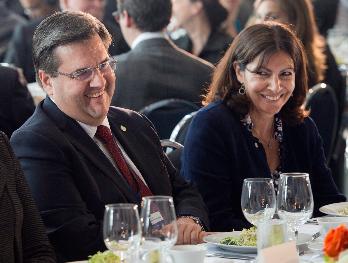 Montreal Mayor Denis Coderre sits with Paris Mayor Anne Hidalgo, during a luncheon at the Summit of Cities, Thursday, June 11, 2015 in Montreal. 