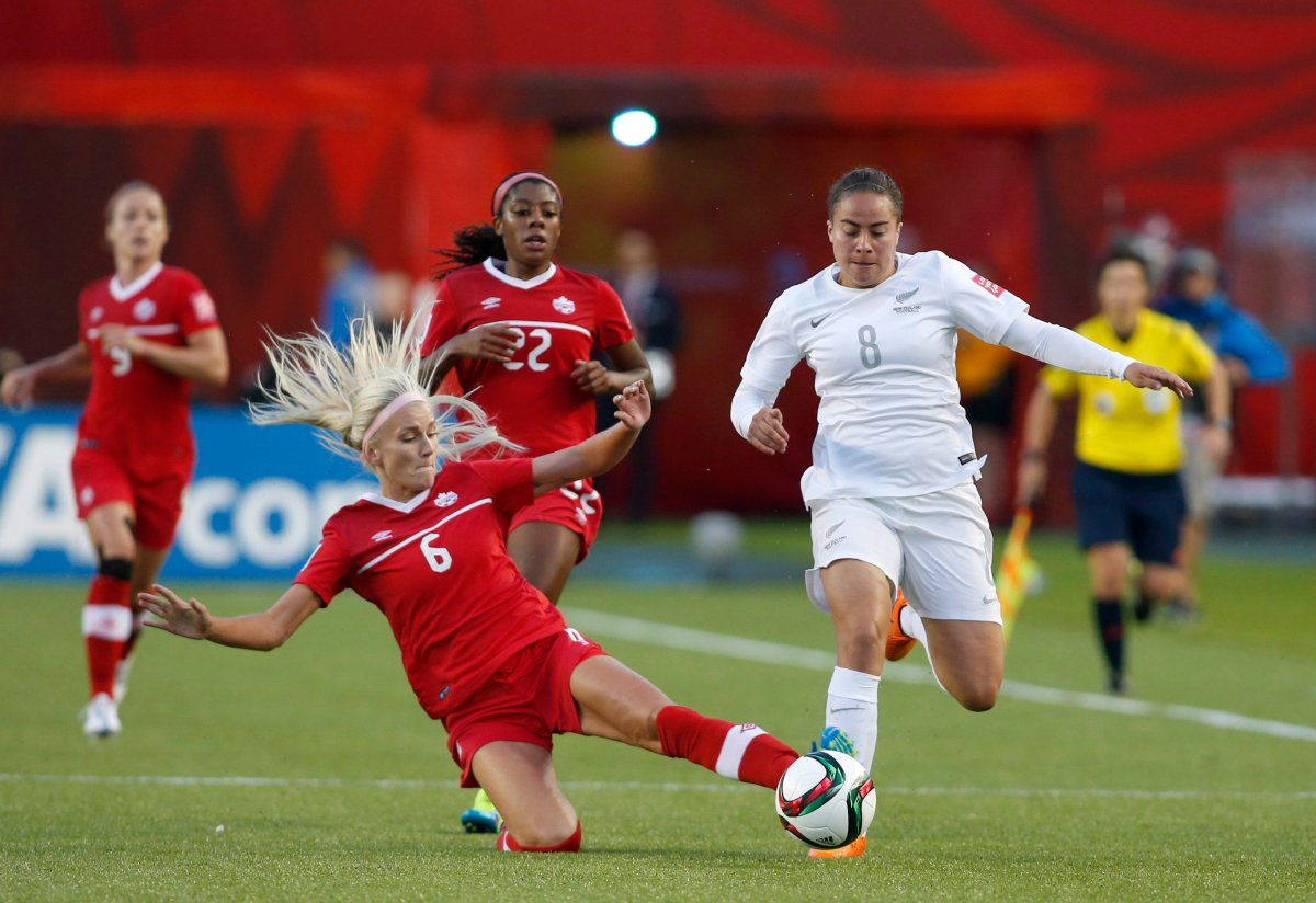 Canada's Kaylyn Kyle slides to stop New Zealand's Jasmine Pereira during second half FIFA Women's World Cup soccer action in Edmonton, Alta., Thursday, June 11, 2015.