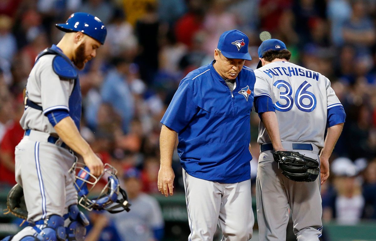 Toronto Blue Jays' Drew Hutchison (36) leaves the game after giving the ball to manager John Gibbons, center, as Russell Martin, left, walks onto the mound during the third inning of a baseball game against the Boston Red Sox in Boston, Friday, June 12, 2015. 