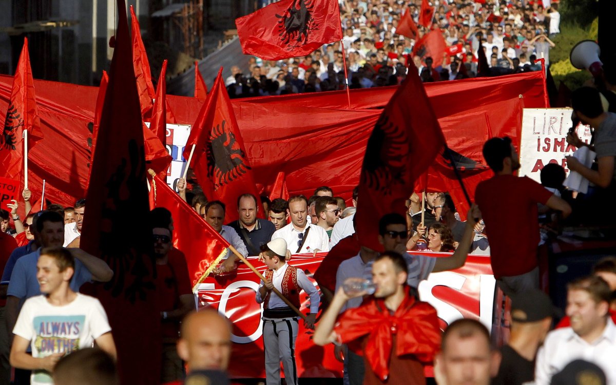 Ethnic Albanians wave Albanian flags while marching through a street in Skopje, Macedonia, on Saturday, June 13, 2015.