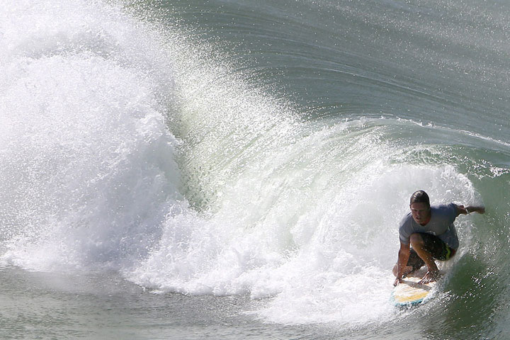 Justin Buxton surfs in Panama City Beach, Fla., on Monday, June 15, 2015. 