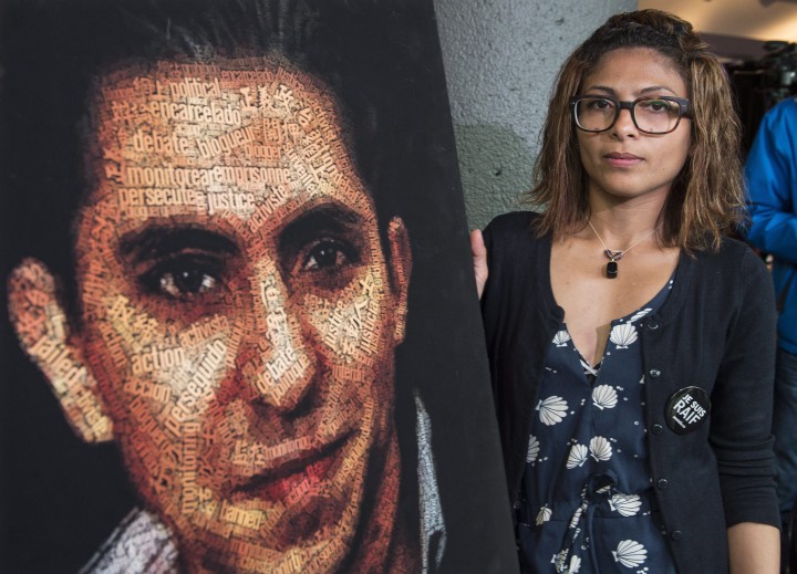 Ensaf Haidar, wife of Raif Badawi, stands next to a poster of a book of articles written by the imprisoned Saudi blogger, Tuesday, June 16, 2015 in Montreal.