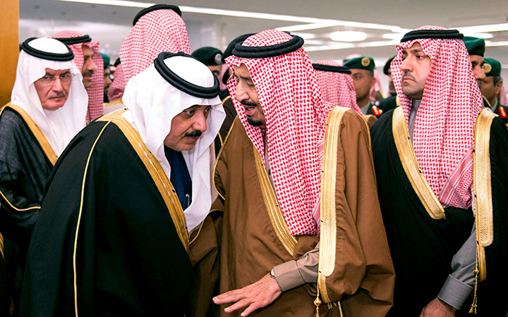 Saudi King Salman, center, speaks to Crown Prince Muqrin, center left, in the king's dewaniya, a traditional Arab reception area to receive guests, where condolences for Saudi King Abdullah, are being received, in Riyadh, Saudi Arabia Jan. 24, 2015.