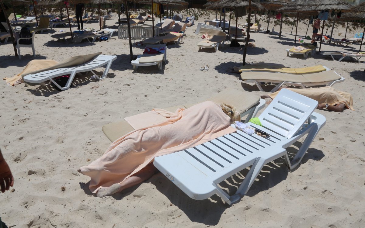 Bodies are covered on a Tunisian beach, in Sousse, Friday June 26, 2015.