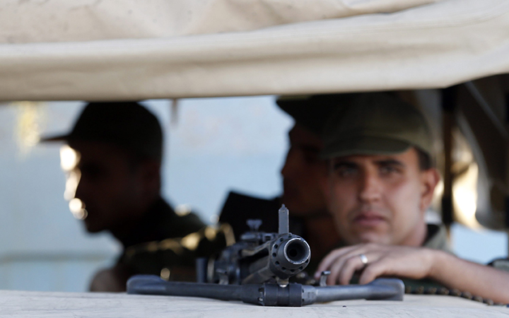Tunisian army soldiers guard the street near the attacked Imperial Marhaba hotel in Sousse, Tunisia, Saturday, June 27, 2015. 
