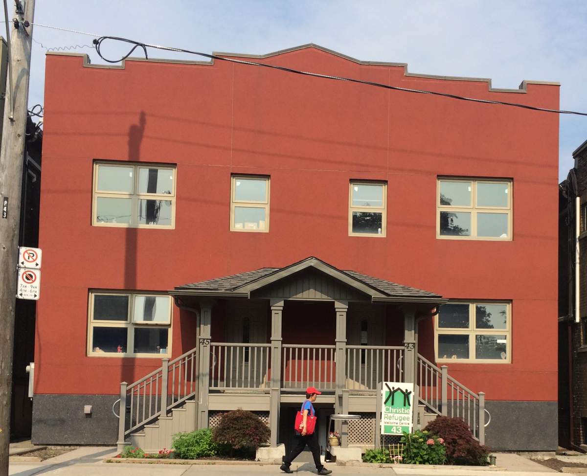 A pedestrian walks past the Christie Street Refugee Centre in Toronto. The centre sees many more inland refugees, who don’t make their claim until they’re already in Canada.