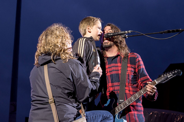 Foo Fighters lead singer invites 8-year-old fan on stage for a performance.