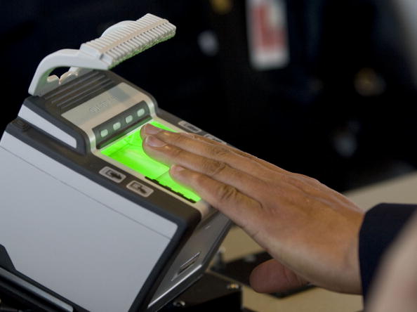 An arriving passenger uses a new biometric scanner at George H. W. Bush Intercontinental Airport February 1, 2008 in Houston, Texas.