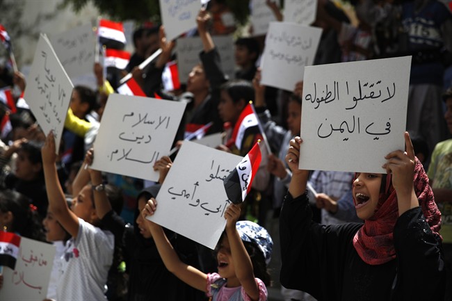 Yemeni children chant slogans during a protest against Saudi-led airstrikes, in Sanaa, Yemen, Saturday, June 6, 2015. 