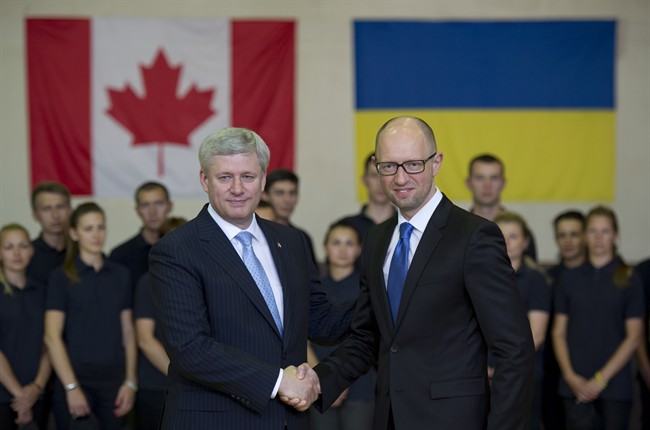 Canadian Prime Minister Stephen Harper shakes hands with Ukraine Prime Minister Arseniy Yatsenyuk during a visit to the Academic Institute of the National Academy of Internal Affairs of Ukraine for Training of Specialists for Public Safety, Psychological Service and National Guard of Ukraine Units in Kyiv.