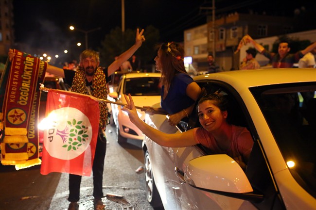 People celebrate election results of the pro-Kurdish Peoples's Democracy Party in Diyarbakir, southeastern Turkey, late Sunday, June 7, 2015. (AP Photo/Emre Tazegul).
