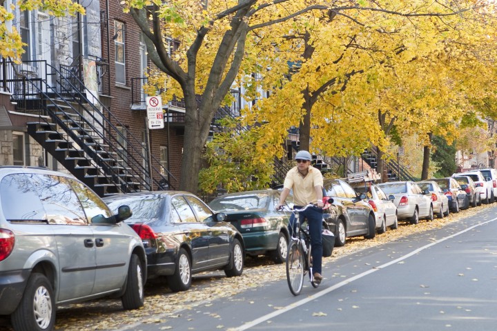 A cyclist rides on a bike path in the Plateau's Mile End borough.