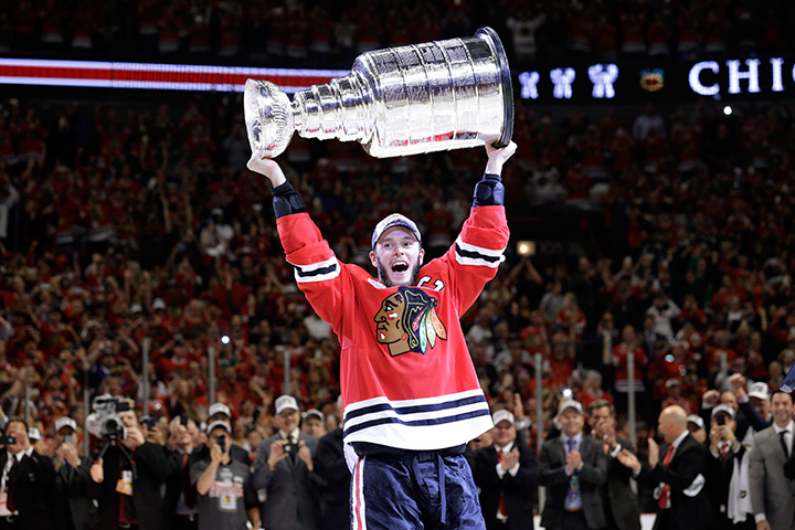 Chicago Blackhawks’ Jonathan Toews hoists the Stanley Cup after defeating the Tampa Bay Lightning in Game 6 of the NHL hockey Stanley Cup Final series on Wednesday, June 10, 2015, in Chicago. 