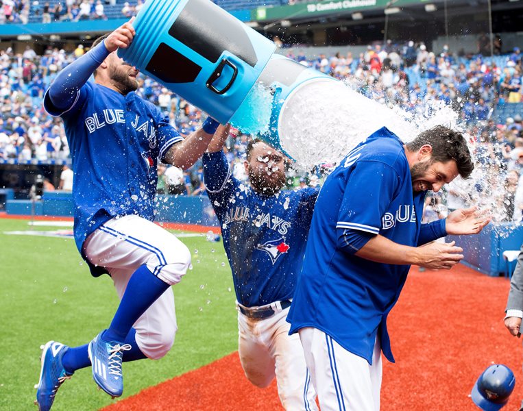 Toronto Blue Jays' Chris Colabello gets a Powerade shower from teammates Kevin Pillar, left, and Russell Martin, centre, after hitting a two-run walk-off single in the ninth inning of MLB action against the Houston Astros on Sunday, June 7, 2015. 