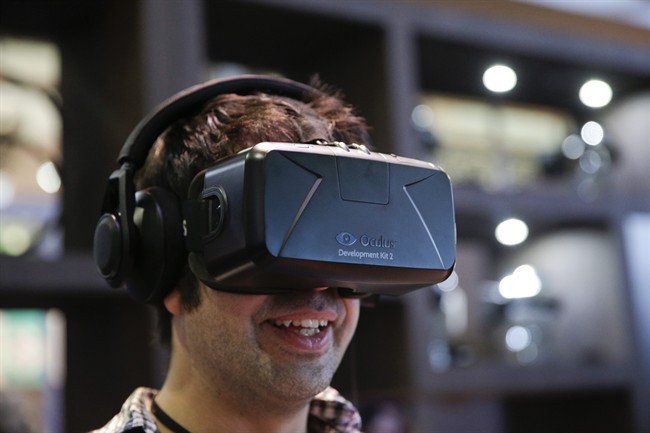In this June 11, 2014 file photo, a man tries out the Oculus Rift virtual reality headset at the Oculus booth at the Electronic Entertainment Expo, in Los Angeles.
