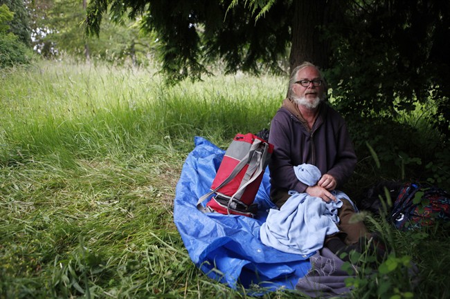 Former printer from Kitchener Waterloo, Dennis Palubeski, after a night's rest in an area in Beacon Hill Park. He and other homeless people, young and old are sleeping in public parks around Victoria, some in tents, others wrapped in plastic tarps and blankets in Victoria, B.C., Thursday June 4 , 2015.